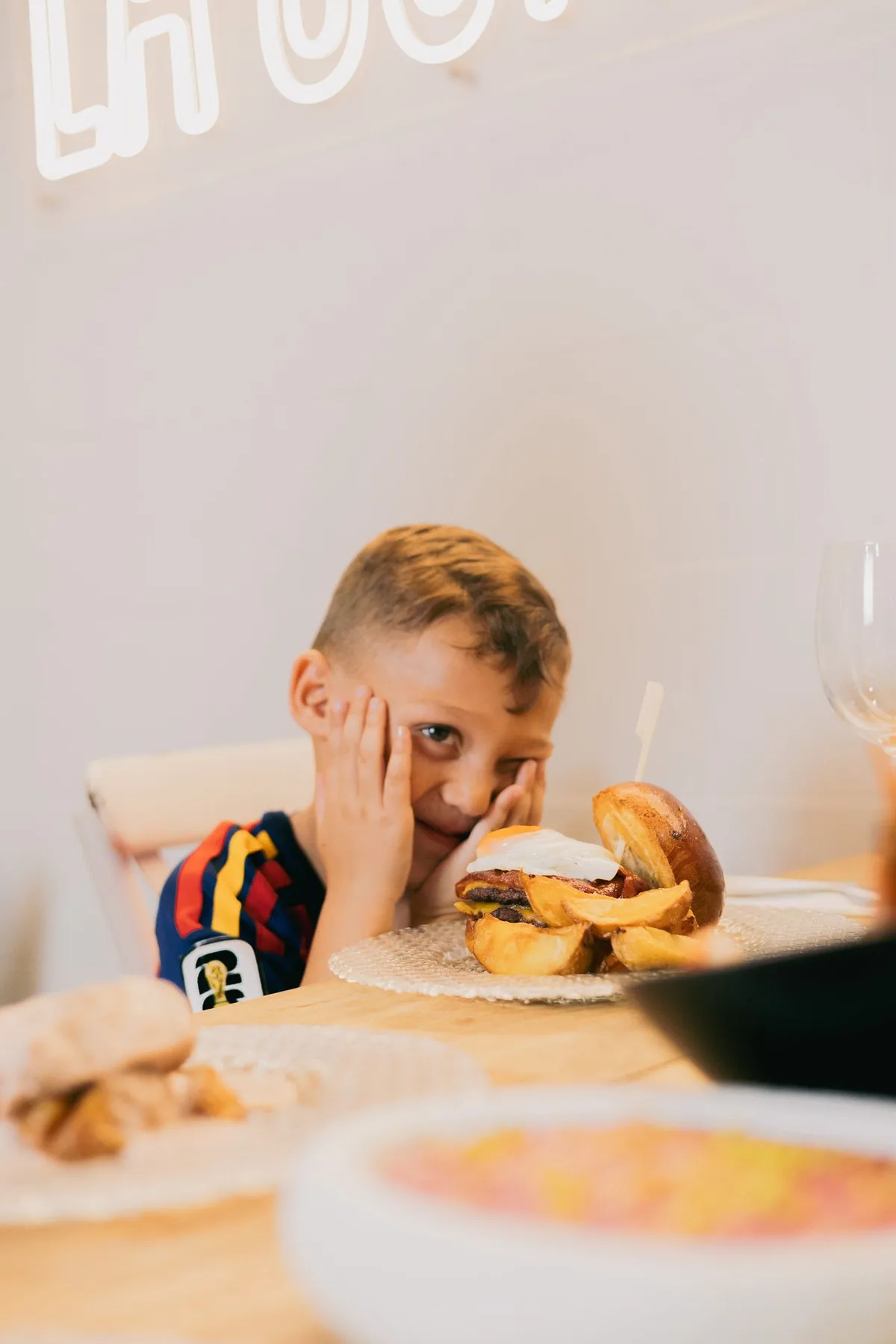 Eric, el hijo de Juan, delante del neón de La Consentida